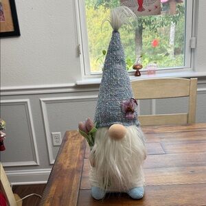 Whimsical Gnome with Blue Hat and Floral Accents